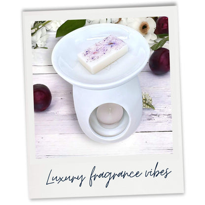 Damson and Patchouli scented wax melt in white wax warmer. Lifestyle image