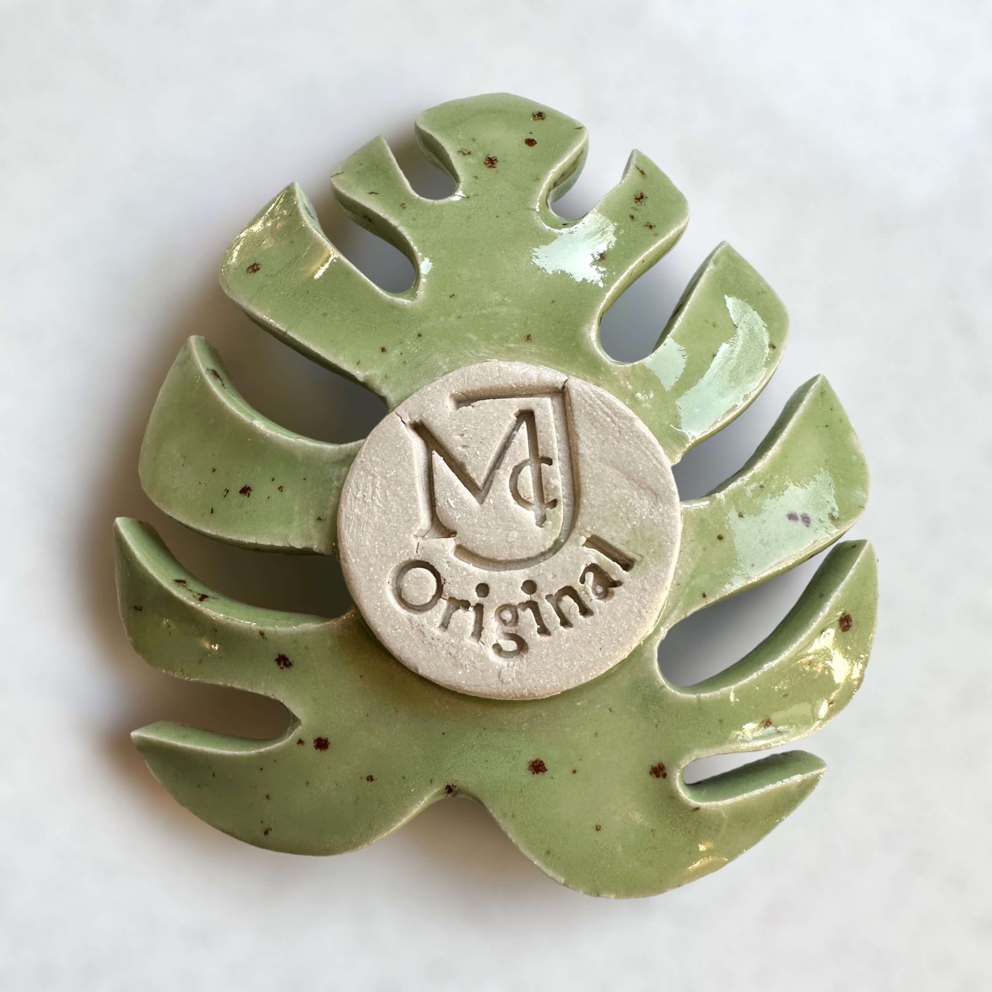 Green tealight holder ceramic Monstera leaf image of base