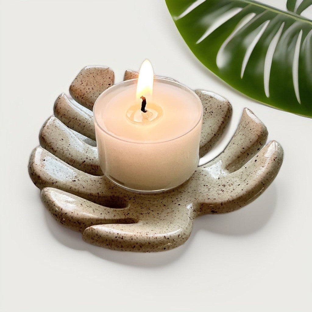 Monstera leaf tealight candle holder with a lit candle life style image