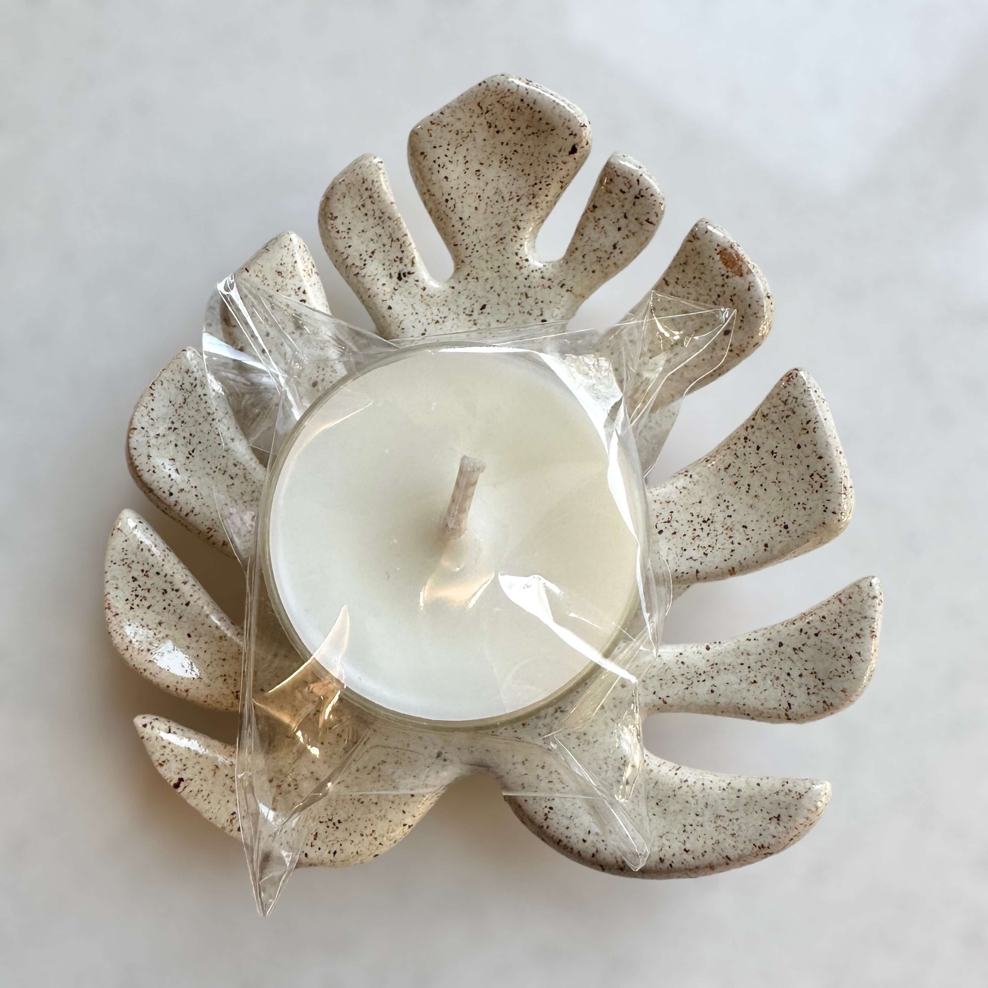 Monstera leaf candle holder with tealight packaged